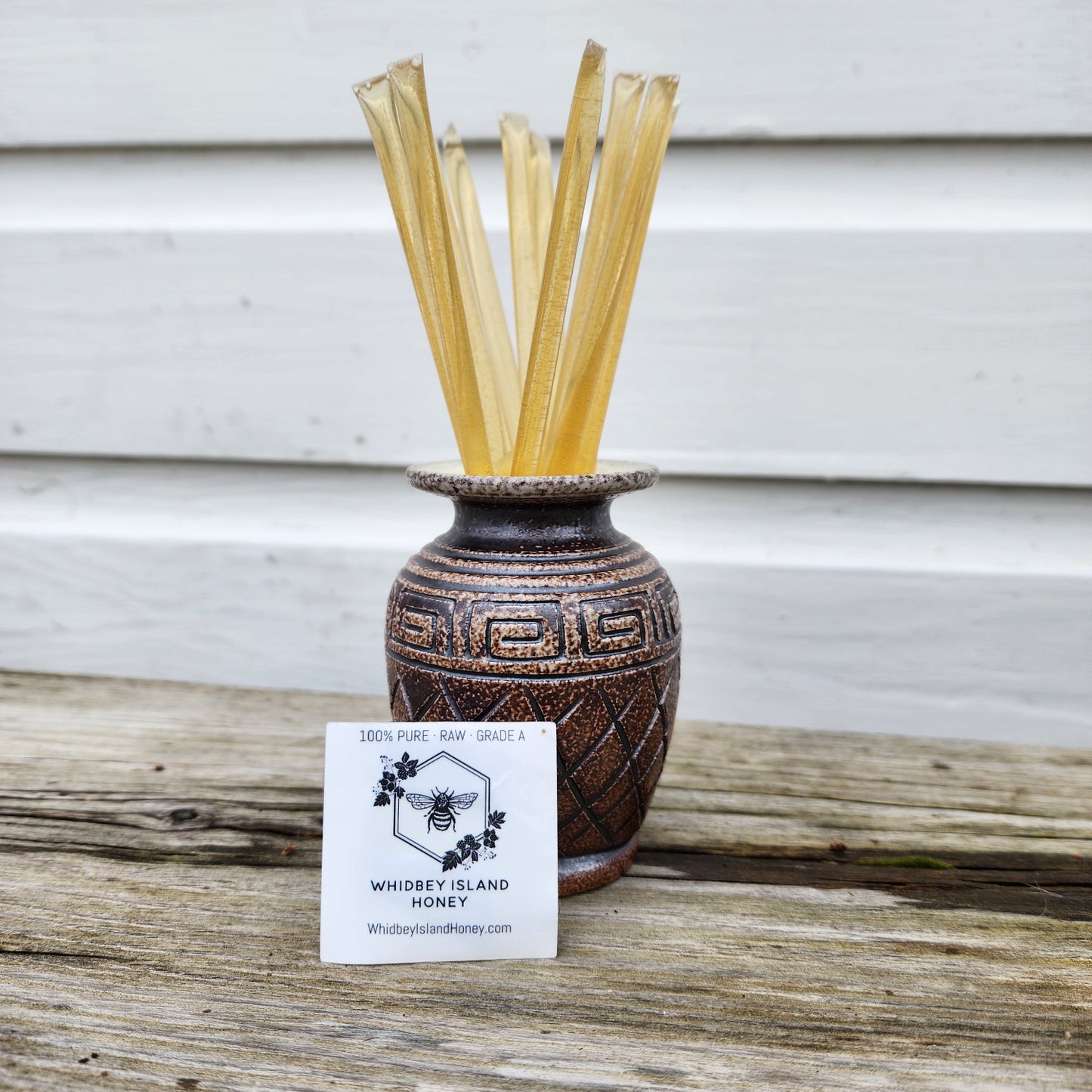 Brown vase with golden honey sticks