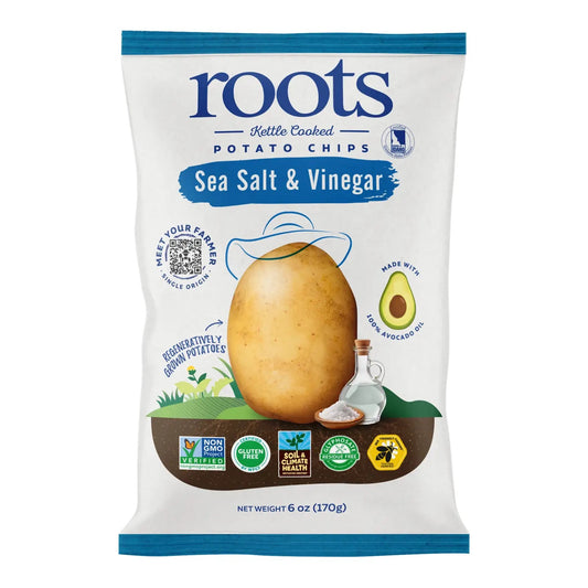 A package of Roots brand Sea Salt & Vinegar kettle-cooked potato chips. The packaging is predominantly white with images of a potato and a chip, and text detailing the flavor and organic certification.