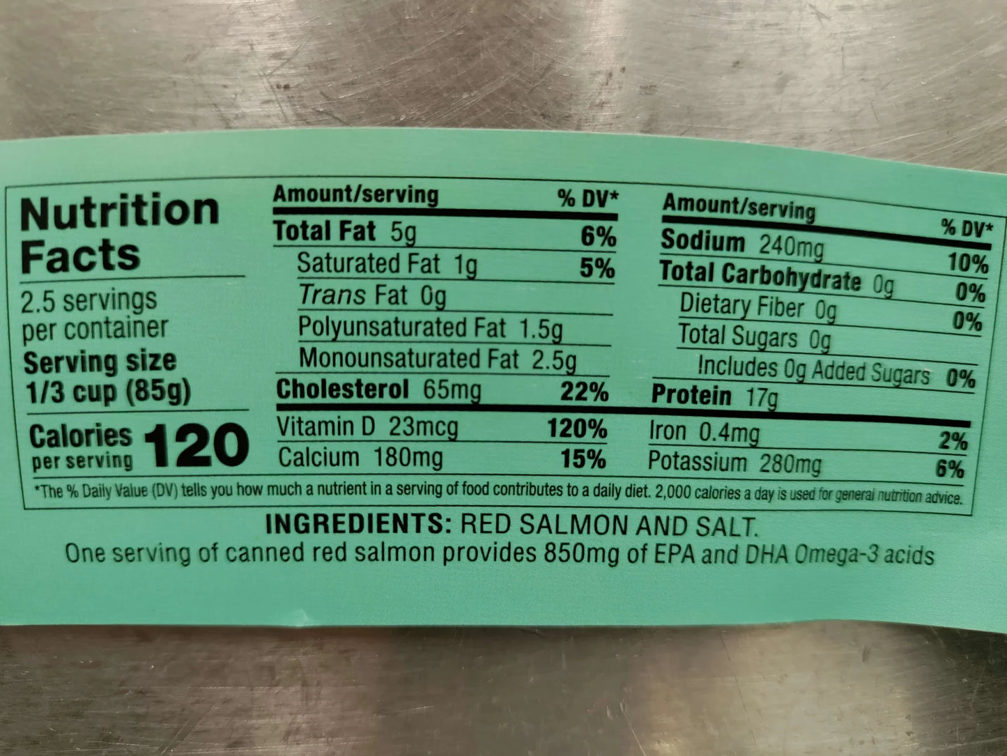 Nutrition facts label for canned red salmon on a metallic surface
