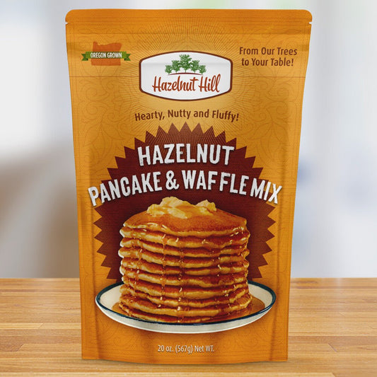 A package of Hazelnut Pancake & Waffle Mix by Hazelnut Hill. The front displays a stack of pancakes with the brand and product name.