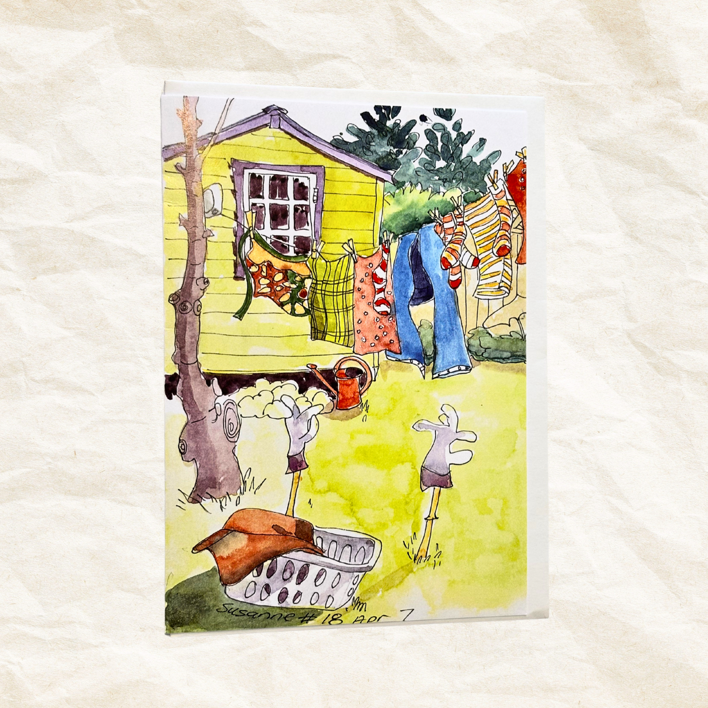 Colorful illustration of a yellow house with a garden and laundry on a textured white background