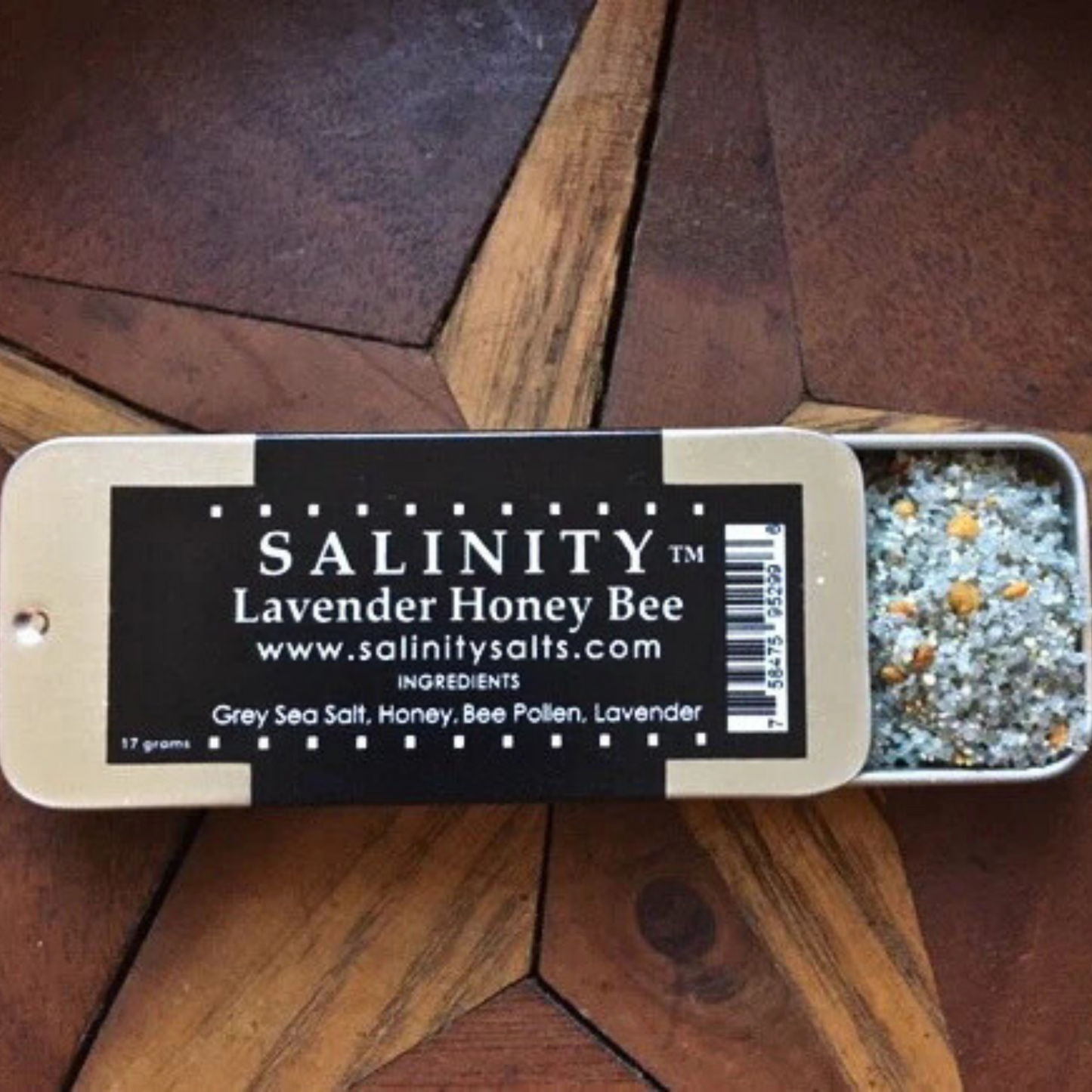 Small metal container open to show contents on a wooden surface