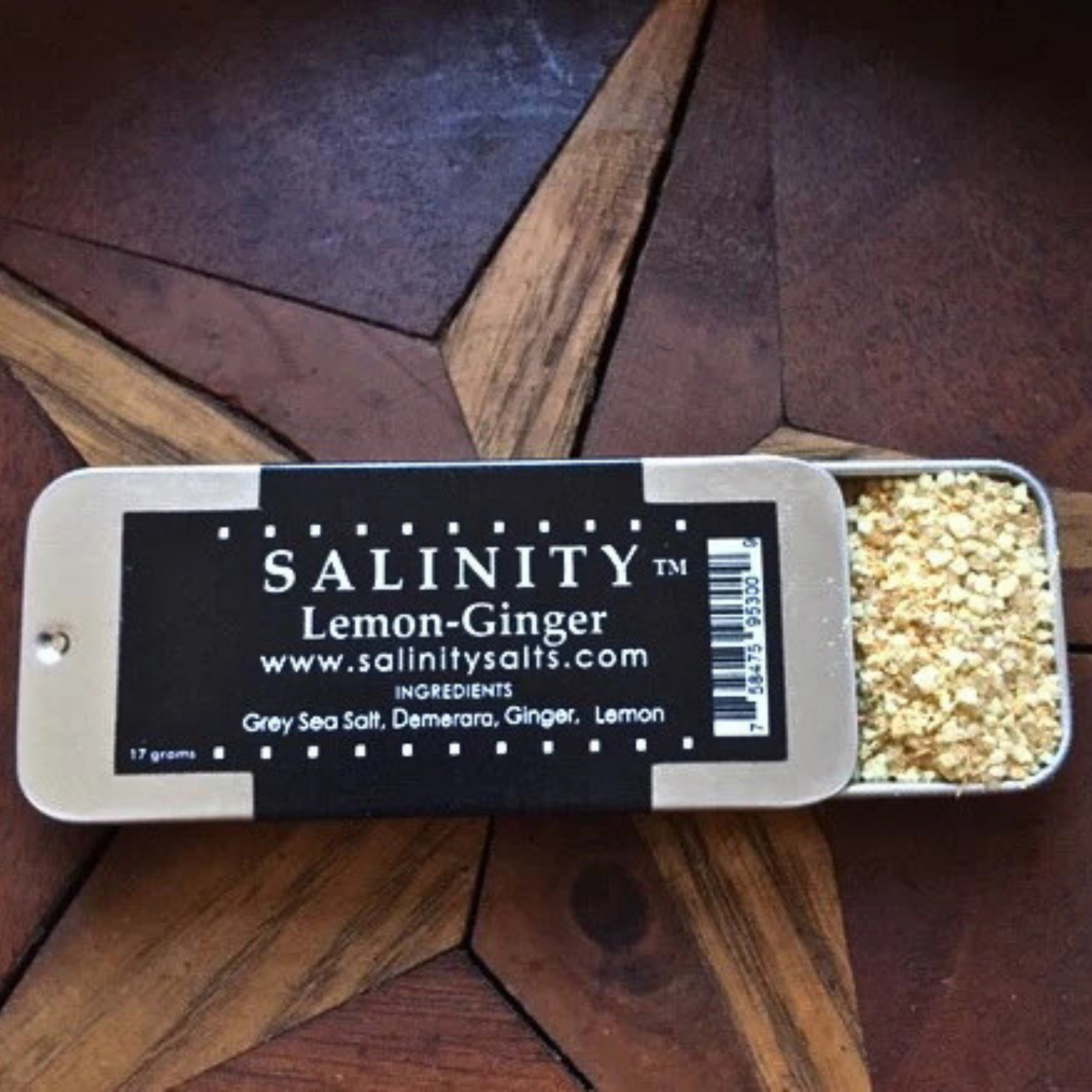 Small metal container open to show contents on a wooden surface