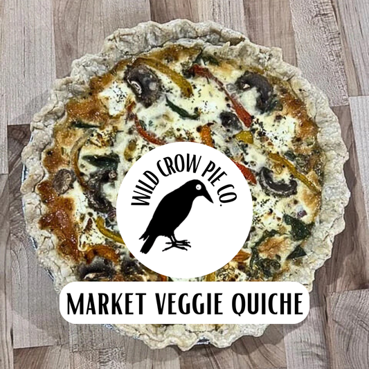 Market Veggie Quiche with Wild Crow Pie Co. branding on a wooden surface