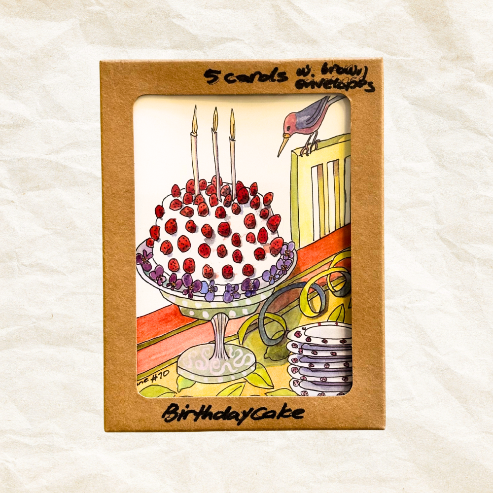 Packaged set of birthday cards with a cake illustration on a textured white background