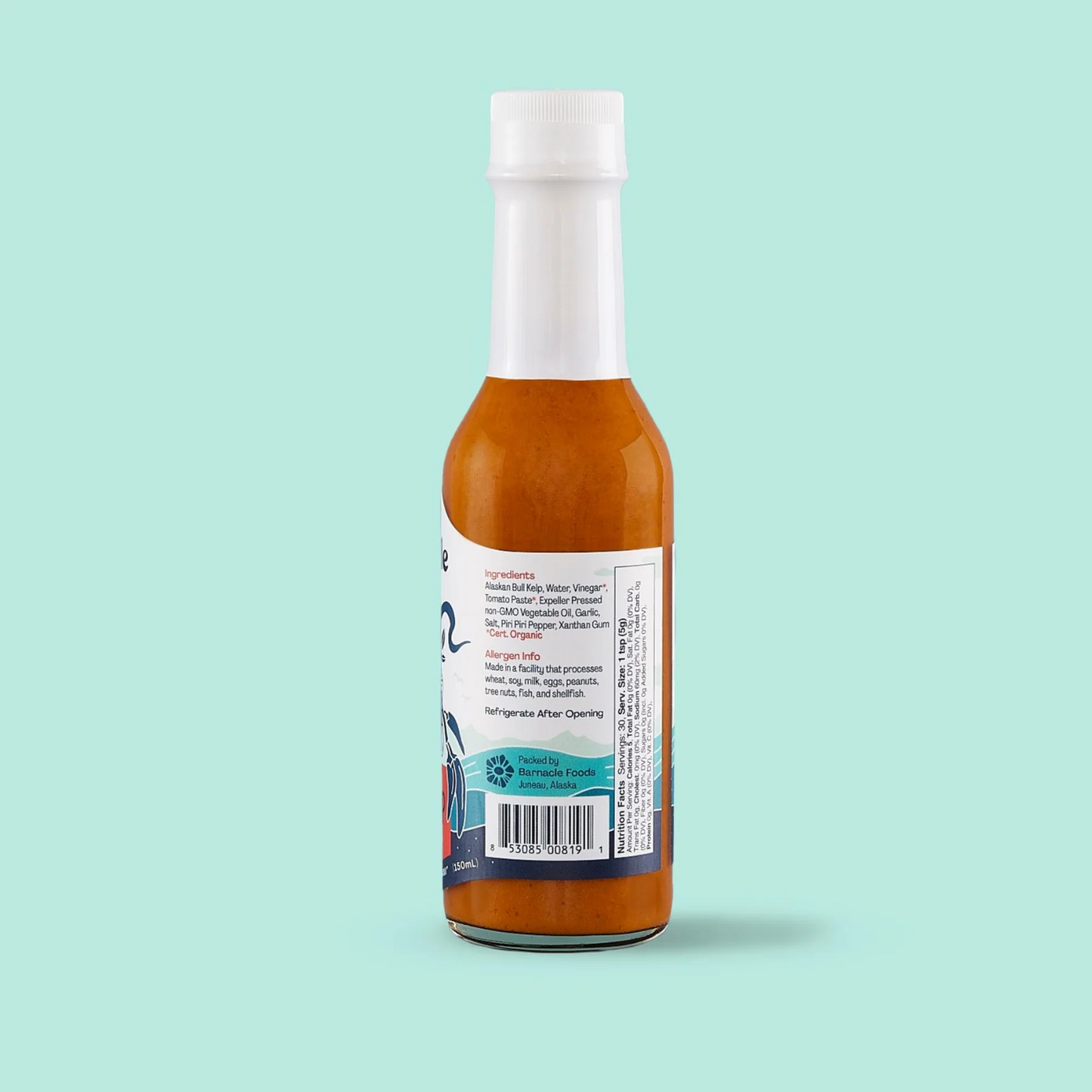 Bottle of hot sauce with a label on a light blue background