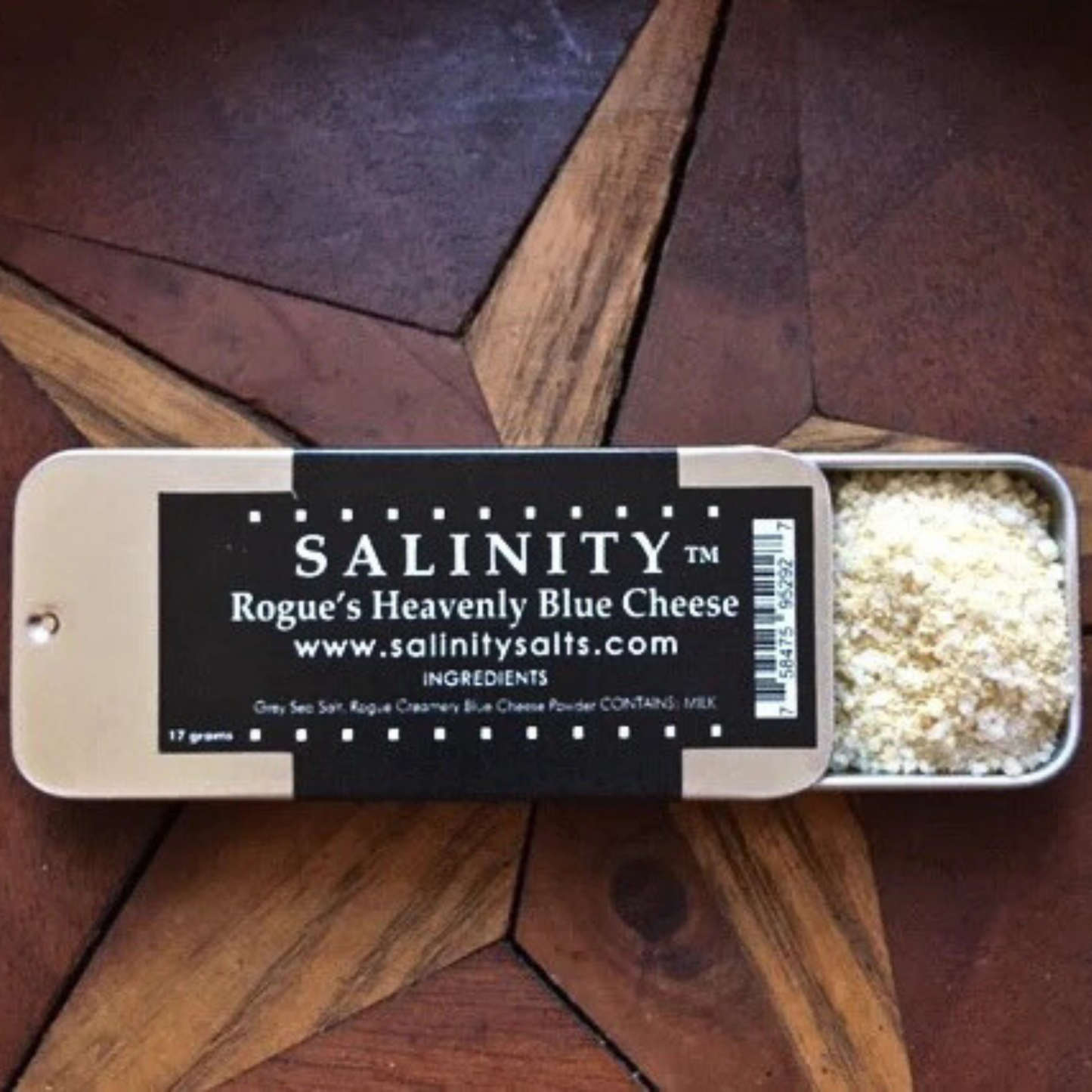 Small metal container open to show contents on a wooden surface