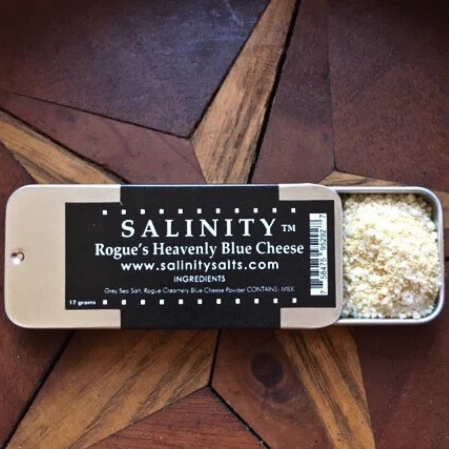 Small metal container open to show contents on a wooden surface