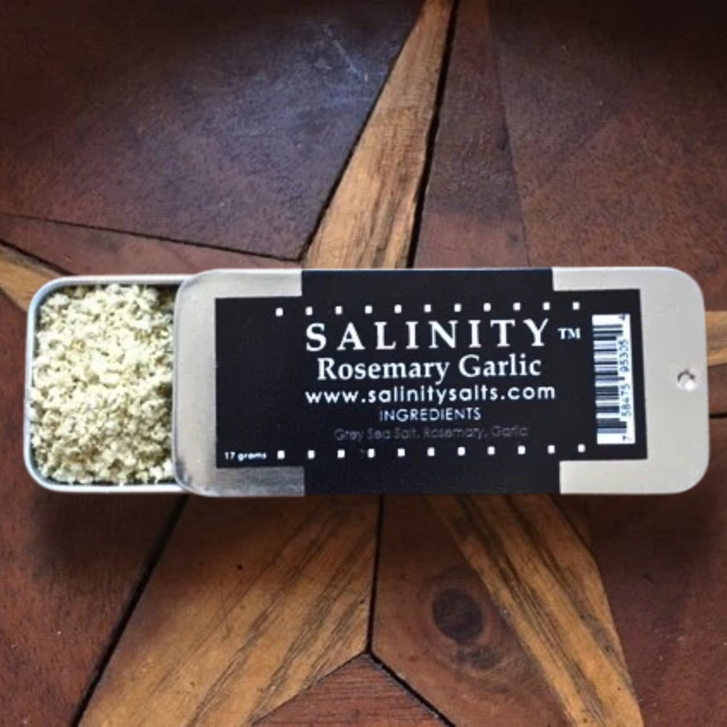 Small metal container open to show contents on a wooden surface