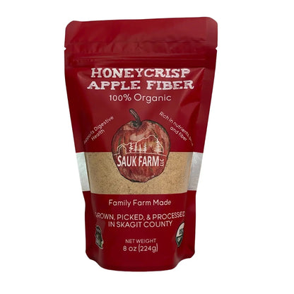 A red resealable bag of Sauk Farm's Honeycrisp Apple Fiber Powder, indicating it is 100% Organic, with an image of an apple on the front.