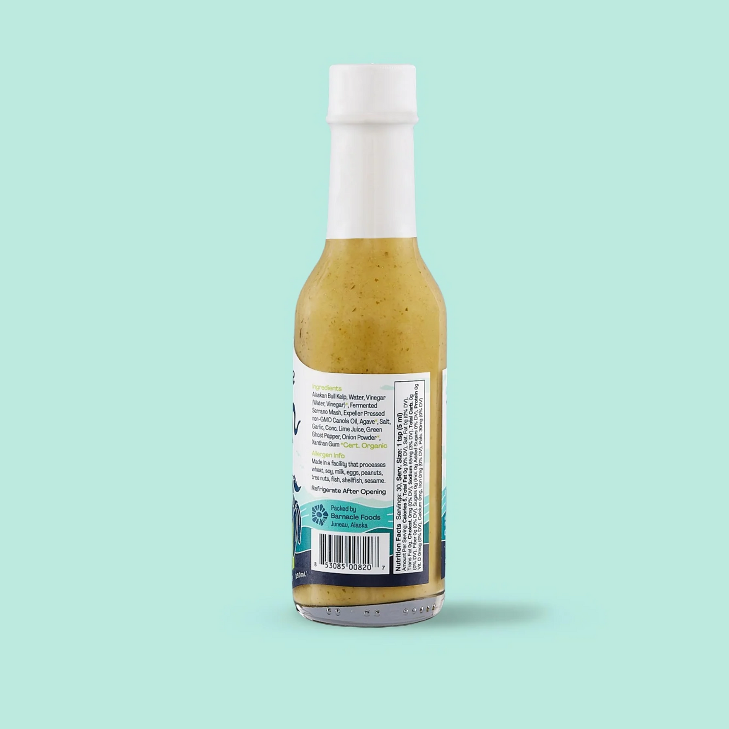 Bottle of hot sauce with label on a light blue background