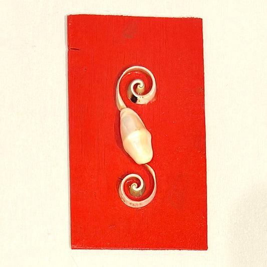 Decorative wall hook with spiral design on a red background