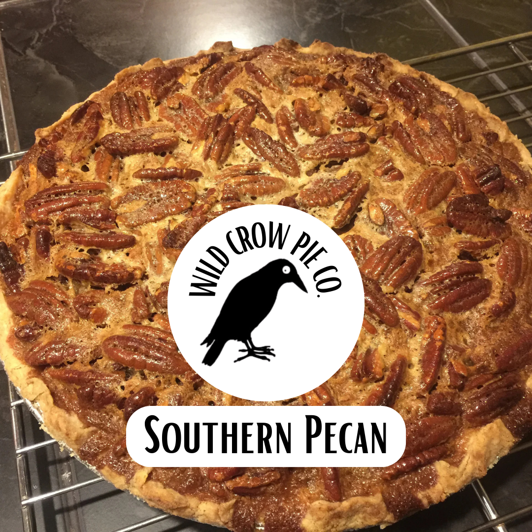 Southern Pecan pie with Wild Crow Pie Co. branding on a metal rack.