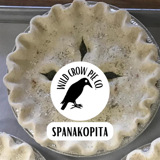 Spanakopita pie with Wild Crow Pie Co logo on a metal tray