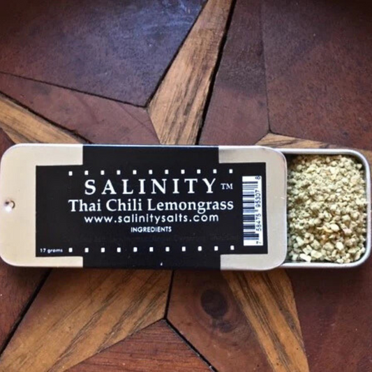 Small metal container open to show contents on a wooden surface