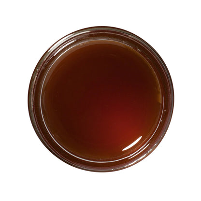 Top view of a jar with a brown substance inside on a white background