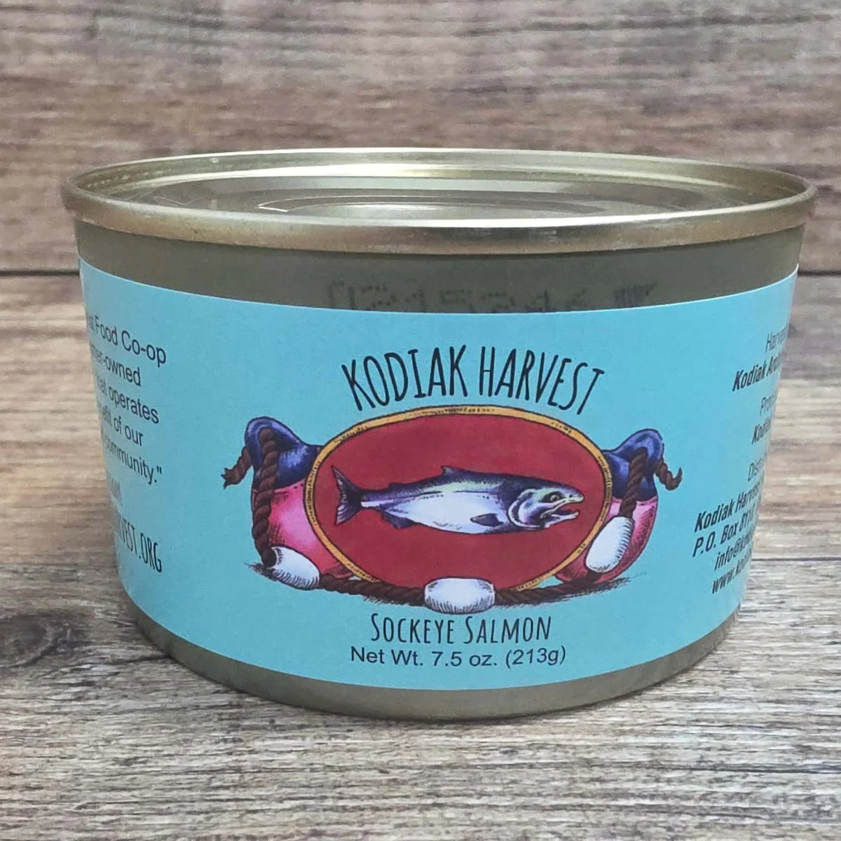 Canned food labeled 'Kodiak Harvest Sockeye Salmon' on a wooden surface