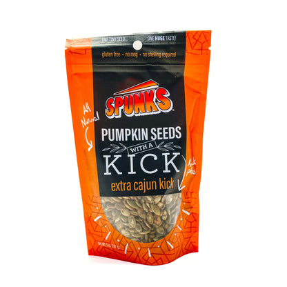 A package of Spunk's Extra Cajun Kick roasted pumpkin seeds. The packaging is predominantly orange with text and design elements featuring images of the seeds.